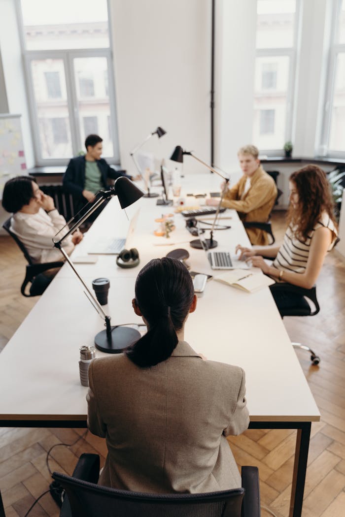about-us-01 Collaborative business meeting in a modern office with diverse colleagues.